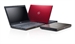 A dark grey open laptop, a red closed laptop, and a slim dark grey tablet.