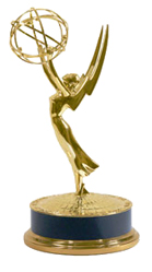 A gold statue of a winged woman holding an atom symbol above a circular base.