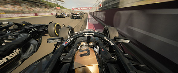 Point of view from inside a black Formula 1 racing car driving on a track behind other cars.