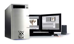 A silver computer tower next to two monitors, a keyboard, and a mouse on a white surface.