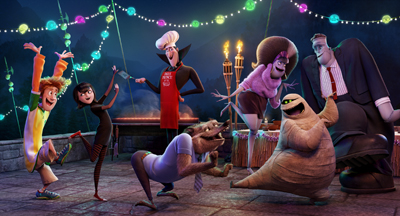 Animated characters, including a tall vampire chef and a mummy, dance under festive string lights at night.