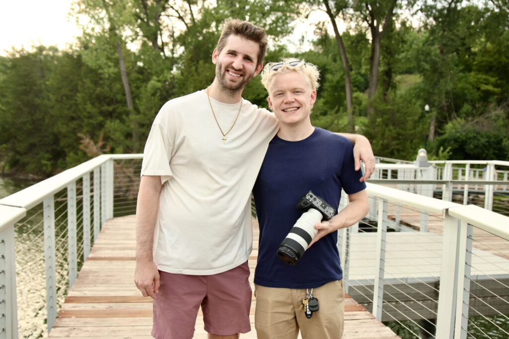 Josh Liljenquist standing with videographer Ben Steine, who is holding a professional camera, at Firemen's Park in Chaska, Minnesota.