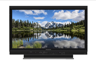 A black Panasonic television screen showing a mountain landscape reflected in a calm lake.