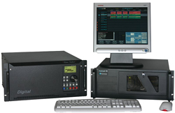 Computer workstation with a monitor displaying data, a keyboard, a mouse, and two black electronic hardware units.