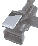 A silver and black electronic device mounted on top of a professional video camera.