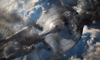 A metallic, saucer-shaped spacecraft with a long neck flying through a cloudy sky.