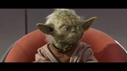 A small, green, wrinkled creature with large ears and white hair sitting in an orange chair.
