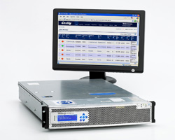 A computer monitor displaying data above a silver rack-mounted server unit on a white background.