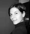 Black and white portrait of a woman with dark hair wearing a dark turtleneck sweater.